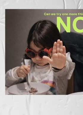 A child in red sunglasses holding up a hand to say no